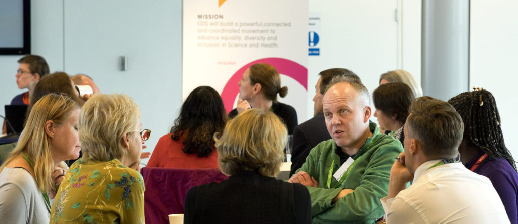 EDIS workshop attendees sit around a table in conversation
